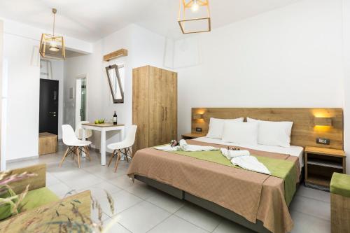a bedroom with a large bed and a table at Castell Hotel in Kissamos