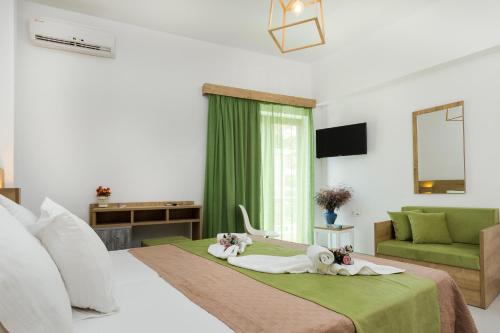 a bedroom with two dolls laying on a bed at Castell Hotel in Kissamos