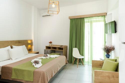 a bedroom with a bed with flowers on it at Castell Hotel in Kissamos