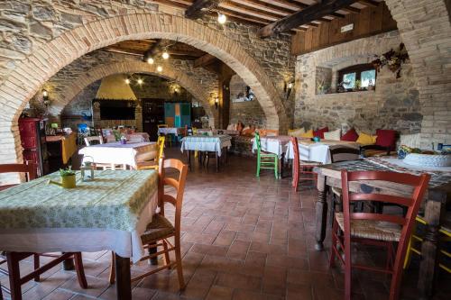 a restaurant with tables and chairs in a stone building at Agriturismo Goccia di Luna in Umbertide