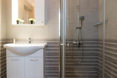a bathroom with a sink and a shower at Acropolis Heights at the foot of the Parthenon in Athens