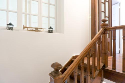 a wooden staircase in a house with a table at Acropolis Heights at the foot of the Parthenon in Athens