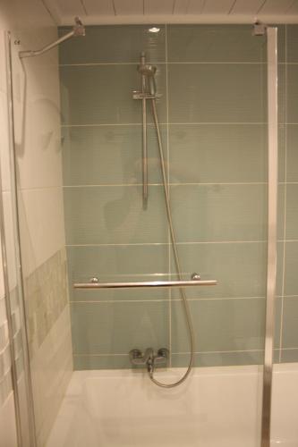 a shower with a glass door in a bathroom at Seastar in Vilamoura