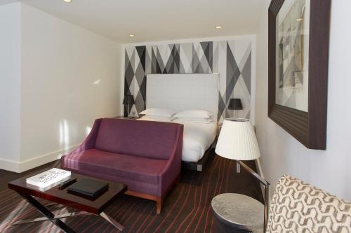a bedroom with a bed and a purple chair at Maison Pic in Valence