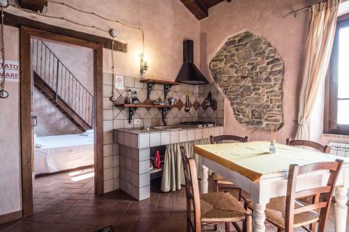 a kitchen with a table and a dining room at Agriturismo Goccia di Luna in Umbertide