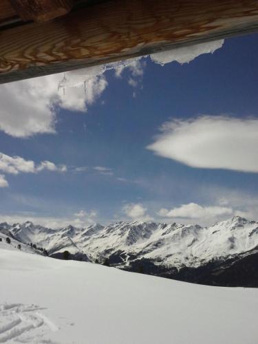 a view of a snow covered mountain from a window at Haus Ladner in See