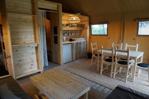 a kitchen and dining room with a table and chairs at Camp Hverringe in Dalby