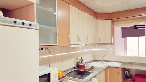 a kitchen with a sink and a microwave at Central Apartment in Valencia with WIFI + Parking. in Valencia