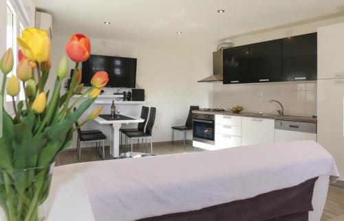a kitchen with a vase of tulips and a table at Holiday Home Rupotina with a large yard, pool and a beautiful view in Solin