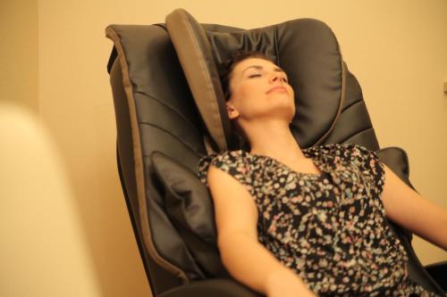 a woman laying in a chair with her head up at Hotel Polaris III in Świnoujście