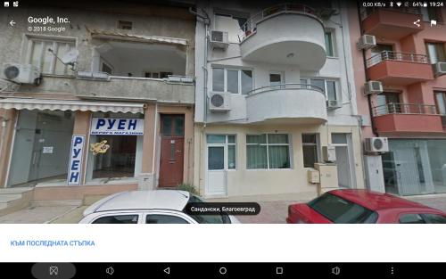 a car parked in front of a building at Apartments Center in Sandanski
