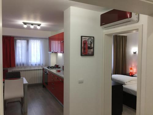 a room with a kitchen and a bedroom with a bed at Luxury Apartment in Galaţi