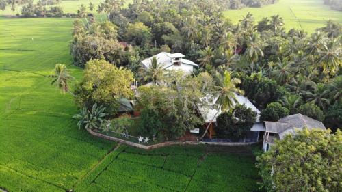 an aerial view of a house in the middle of a field at Moon Light Guest House in Tissamaharama