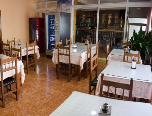 jadalnia ze stołami i krzesłami w restauracji w obiekcie Hotel Praderón w mieście San Sebastián de los Reyes