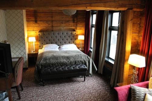 a bedroom with a bed in a wooden room at Det Hanseatiske Hotel in Bergen