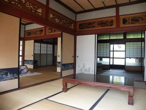 a room with a table in the middle of it at Noukaminsyuku Zakuro no Yado / Vacation STAY 15439 in Sabae