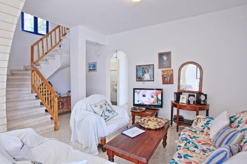 a living room with a couch and a table at Villa Mandola Rosa in Prodhromi