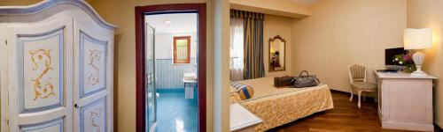 a hotel room with a bed and a bathroom at Punta Campanella Resort & Spa in Massa Lubrense