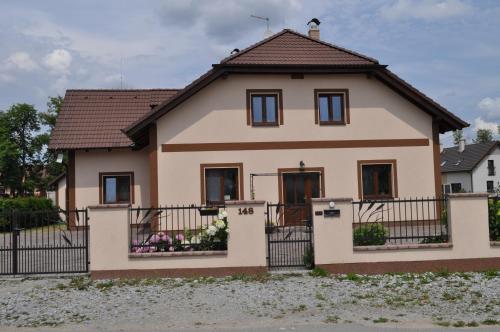 a house with a fence in front of it at Penzion Domanín in Třeboň