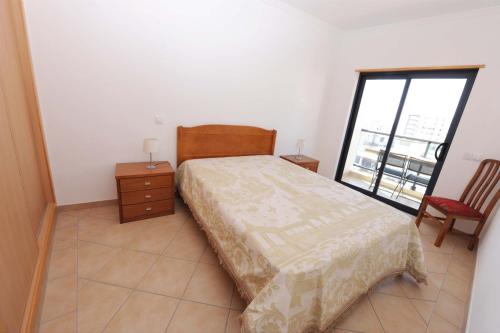 Posteľ alebo postele v izbe v ubytovaní Quarteira Beach