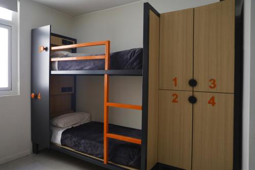 a bunk bed room with two bunk beds and a closet at America Del Sur Hostel Buenos Aires in Buenos Aires
