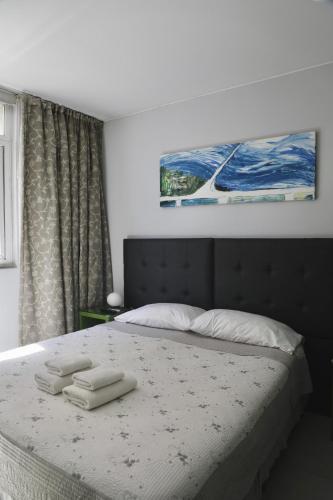 a bedroom with a bed with two towels on it at America Del Sur Hostel Buenos Aires in Buenos Aires