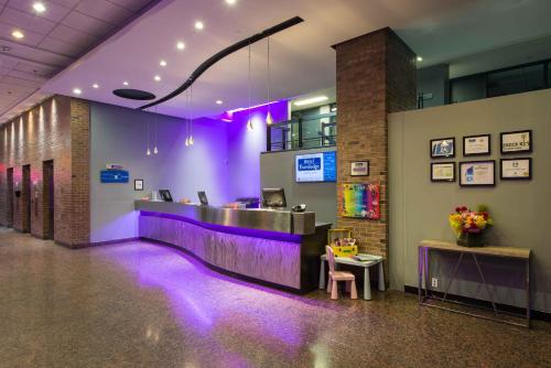 a lobby with purple lighting in a building at Travelodge by Wyndham Montreal Centre in Montréal