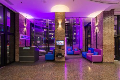 a lobby with purple lighting in a building at Travelodge by Wyndham Montreal Centre in Montréal