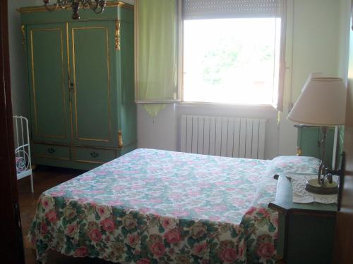 a bedroom with a bed and a window and a dresser at B&B da Debora in Pisa