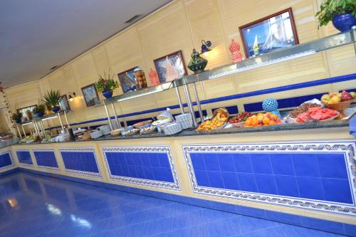 a buffet line in a restaurant with fruits and vegetables at Regency Hotel & Spa in Monastir