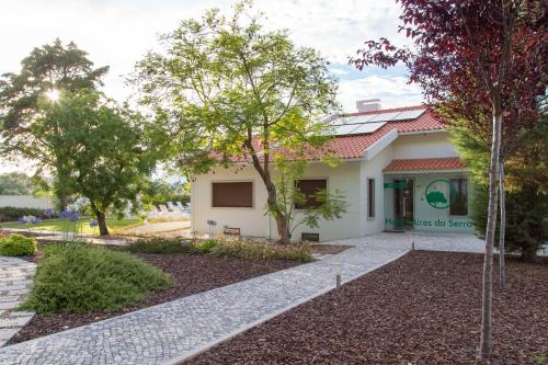 a house with a garden in front of it at Aires da Serra Hotel in Torres Novas