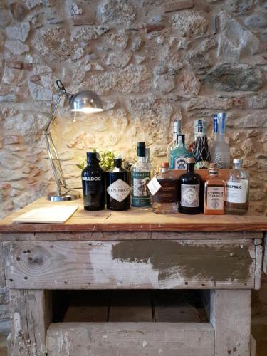 a wooden table with bottles of alcohol on it at Art Hotel Pietrasanta in Pietrasanta