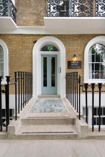 a front door of a building with a blue door at Angus Hotel in London