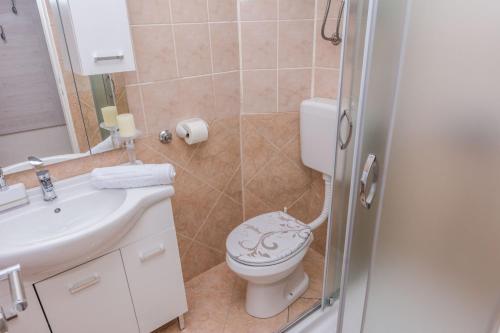 a bathroom with a toilet and a sink at Apartments Marina in Zadar