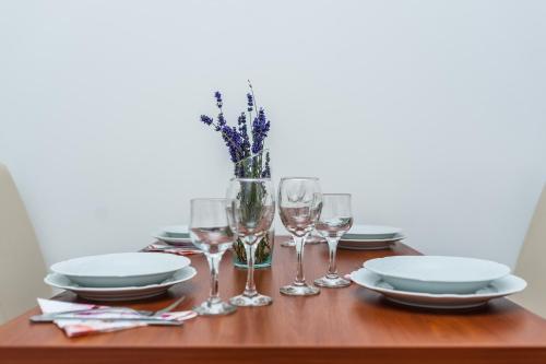 a table with plates and wine glasses on it at Apartments Marina in Zadar