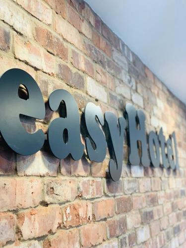 a sign for a store on a brick wall at easyHotel Ipswich in Ipswich