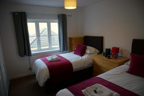 a hotel room with two beds and a window at The Coach House in Bristol