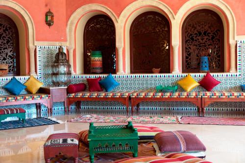a room with red and blue pillows in a building at Regency Hotel & Spa in Monastir