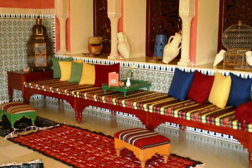 a room with two benches with different colored pillows at Regency Hotel & Spa in Monastir
