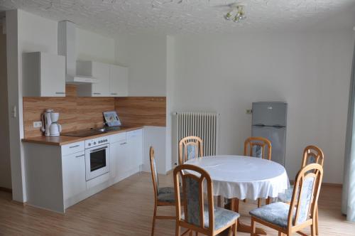 a kitchen with a table and chairs in a kitchen at Ferienwohnungen Familie Jarnig Inge in Görtschach