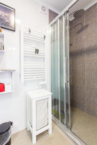 a bathroom with a shower and a white table at Cozy place in Lisbon 23 in Lisbon