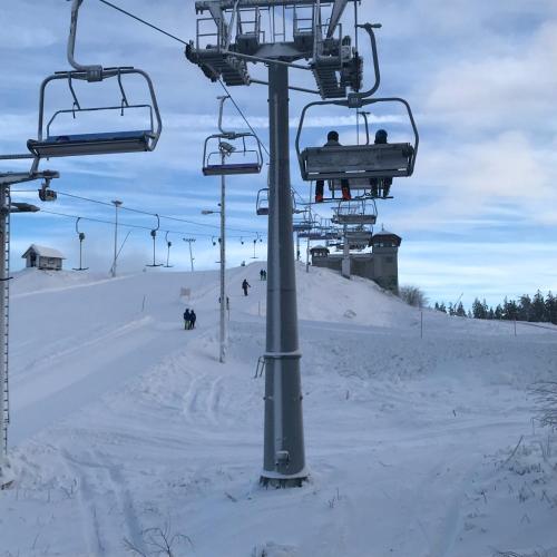 two people riding a ski lift in the snow at Nina`s GuestHouse, Jämsä City, 160 m2, Include x2 Himos Ski Pass in Jämsä