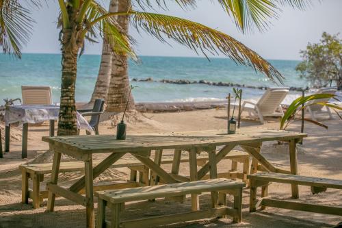 a picnic table and chairs on the beach at Tintipan Cabana SalSiPuedes in Tintipan Island