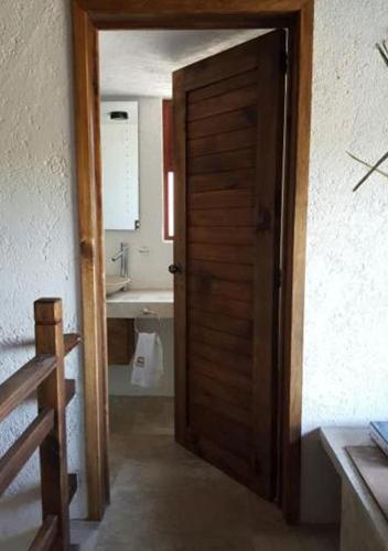 a door leading into a bathroom with a sink at La Mora Casa de Campo in Huasca de Ocampo