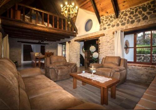 a living room with a couch and chairs and a table at La Mora Casa de Campo in Huasca de Ocampo