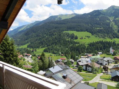 a view from the balcony of a village in the mountains at Gästehaus am Berg in Hirschegg