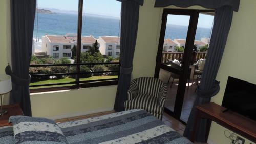 a living room with a couch and a view of the ocean at Departamento Puerto Velero in Puerto Velero