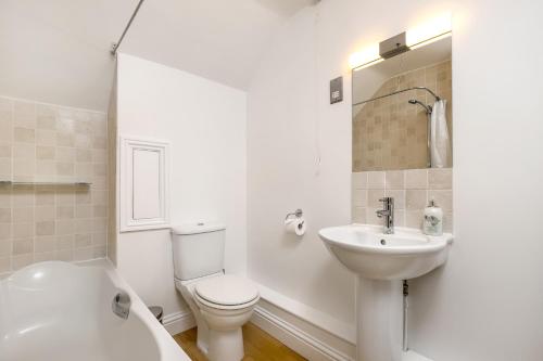 Baño blanco con aseo y lavamanos en Gorgeous Apartment in the centre of Winchester, en Winchester