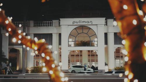 a building with cars parked in front of it at Pullman Cairns International in Cairns