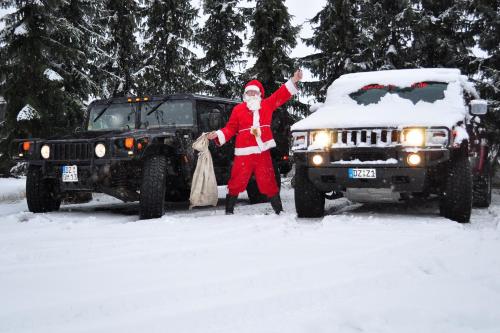 a man dressed as santa claus standing next to a jeep at Hotel-Pension Grüne Linde in Delitzsch